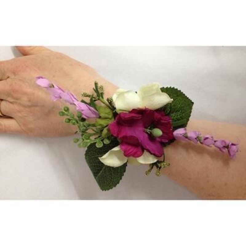 This artificial flower wrist corsage if perfect for Prom Parties or Festivals. The flowers are set onto a cream satin faced snap wristlet so fit any size wrist.